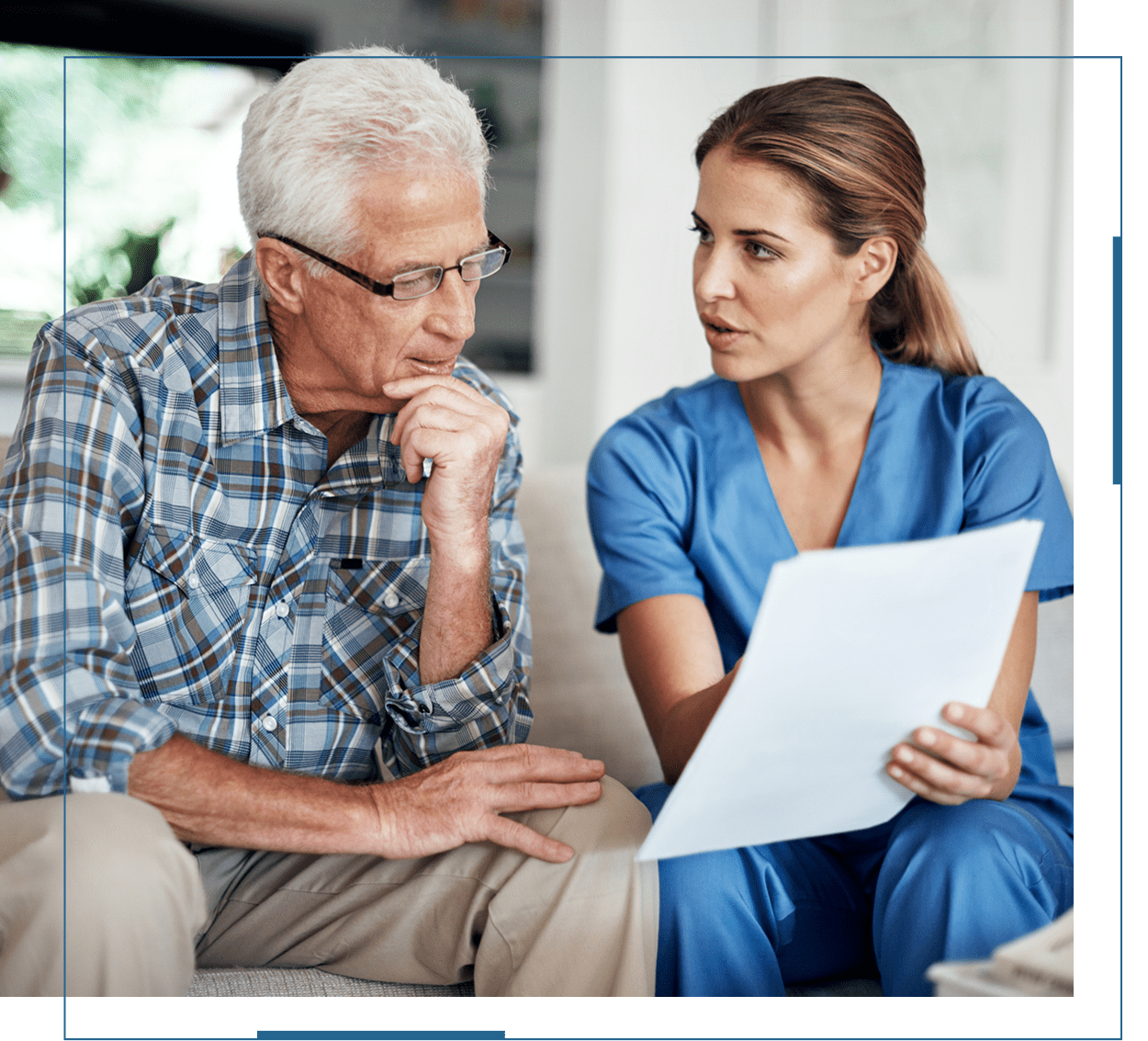 Nurse discussing medical information with elderly man.