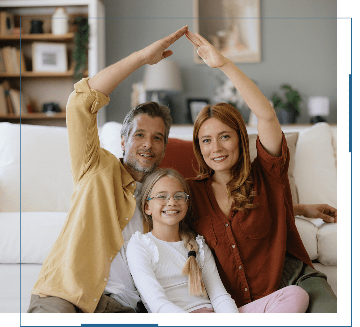 Happy family of three posing together and smiling indoors.