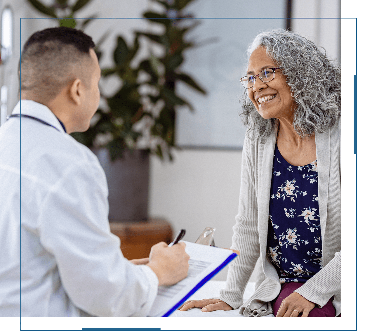 Doctor consulting an elderly woman with a smile.