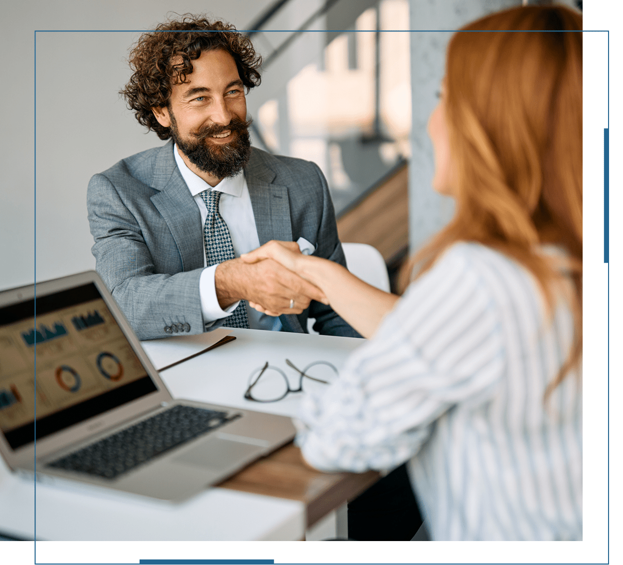 Two professionals shaking hands during a business meeting.