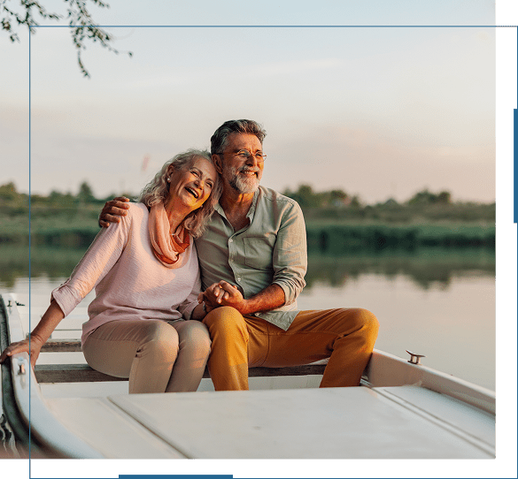 Couple enjoying a serene moment on a boat at sunset.